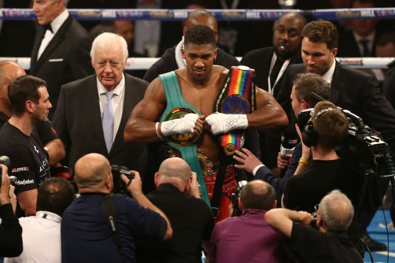 Anthony Joshua celebrates beating Dillian Whyte in the British and Commonwealth heavyweight title match at the O2 arena in London on December 12, 2015