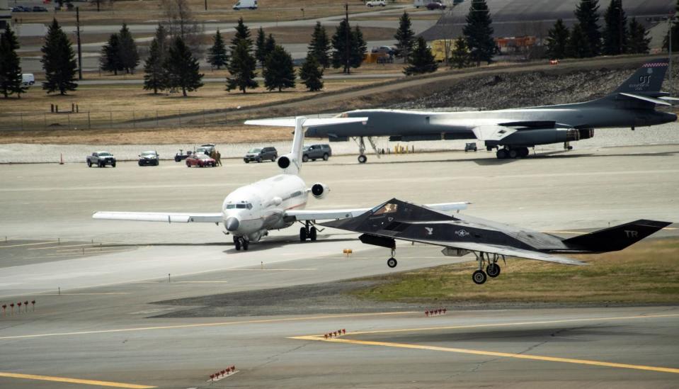 An F-117 aggressor recovers from a Northern Edge sortie, with Pantheon's 727 test jet and an B-1B in the background. Northern Edge is a critical set of test-focused war games that help prove emerging technologies and especially those surrounding networking. (USAF)