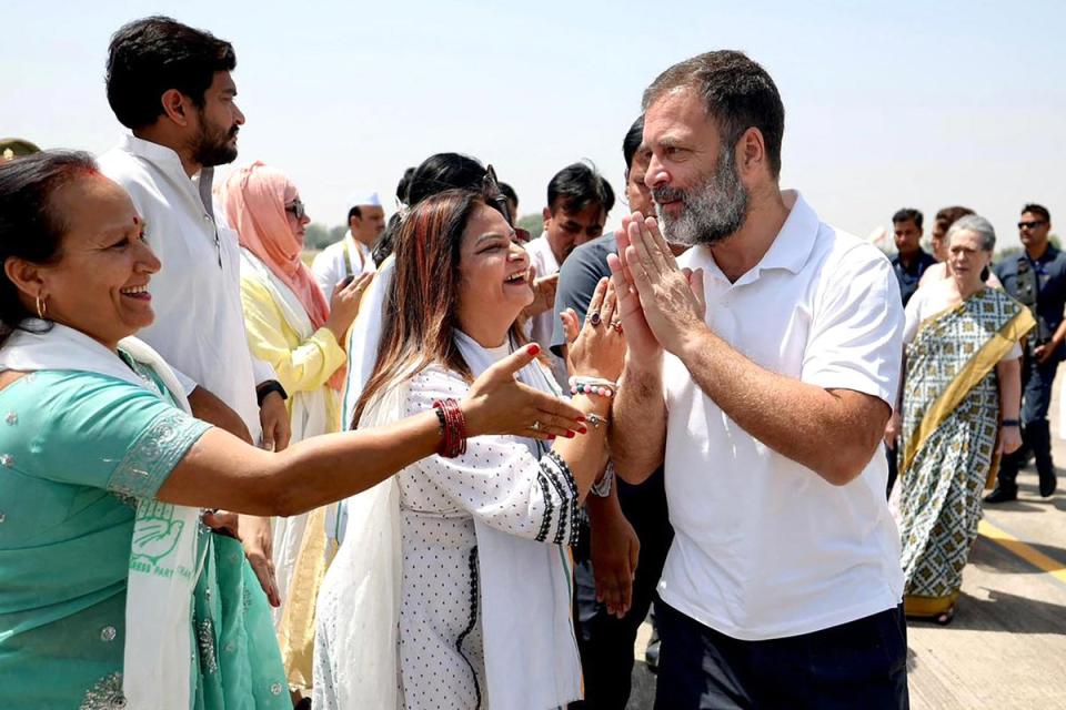 Rahul Gandhi greets his supporters as he arrives at Fursatganj airport in Amethi last month (AFP)