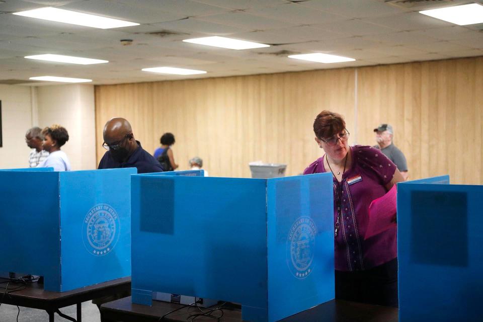 The Poll Manager logs into a voting machine as voters cast their ballots on Tuesday May 24, 2022 at the Progressive Recreation Center in Garden City, Georgia.