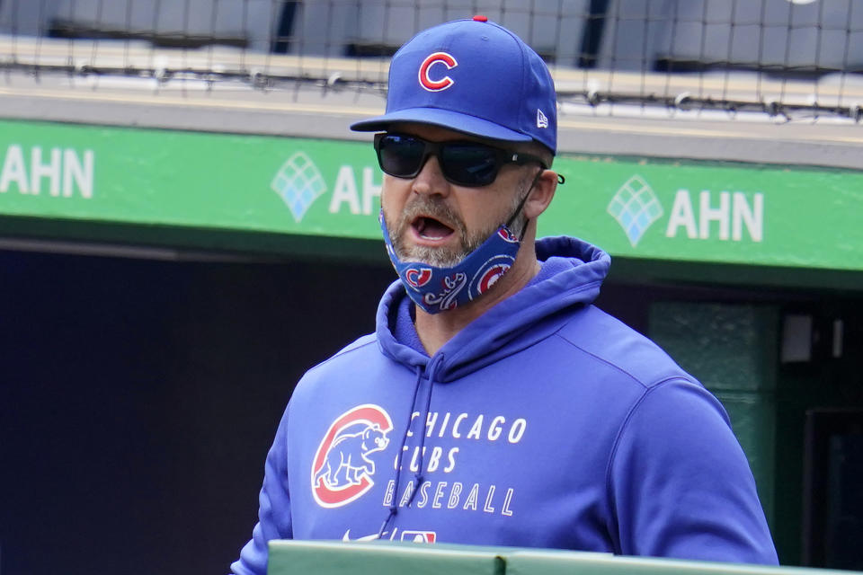 Chicago Cubs manager David Ross stands in the dugout during a baseball game against the Pittsburgh Pirates in Pittsburgh, Sunday, April 11, 2021. (AP Photo/Gene J. Puskar)