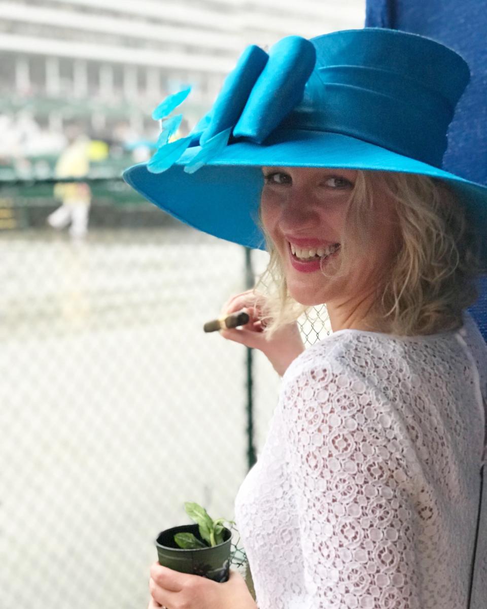 Courier Journal freelancer writer Dana McMahan enjoys her customer Kentucky Derby cigar with her mint julep at the 2018  Kentucky Derby.