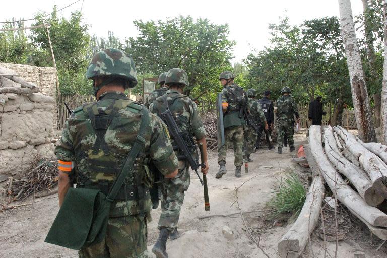 Police look for fugitive "terrorists" in Aksu, in northeast China's Xinjiang region, August 9, 2014