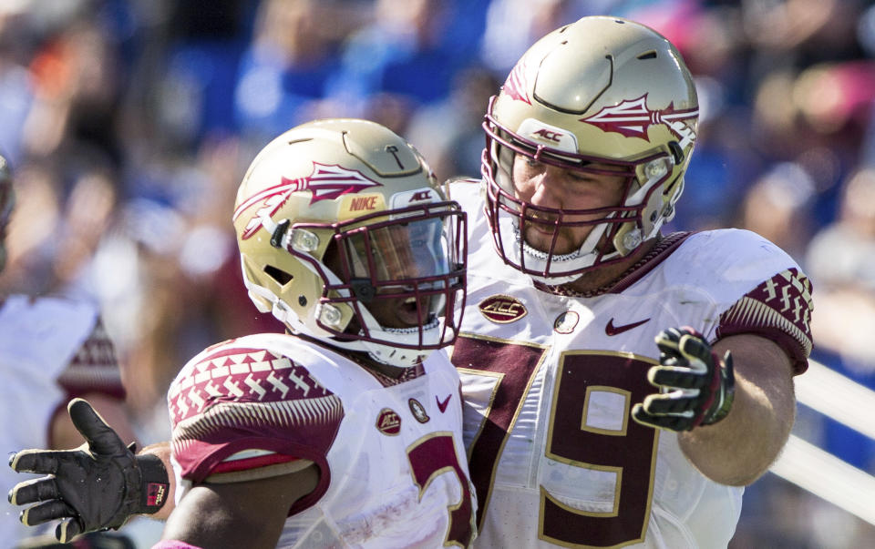 Florida State’s Cam Akers (3) celebrates with teammate Josh Ball (79) after scoring a touchdown during the second half of an NCAA college football game against Duke in Durham, N.C., Saturday, Oct. 14, 2017. Florida State beat Duke 17-10. (AP Photo/Ben McKeown)