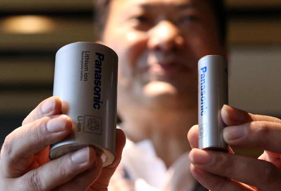 Kazuo Tadanobu, CEO of Panasonic's Energy Company holds a prototype of the 4680 format battery cell (L) next to the current 2170 battery supplied to Tesla Inc during a news conference in Tokyo, Japan October 25, 2021.REUTERS/Tim Kelly