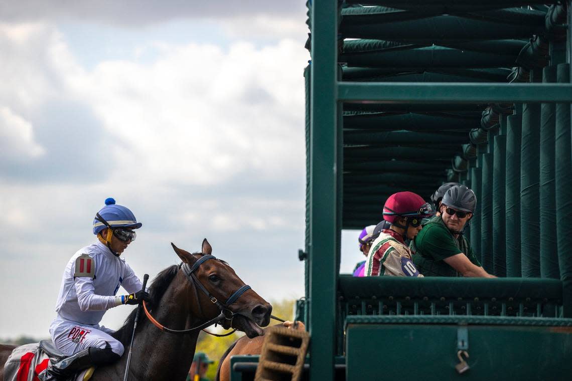 Horses are loaded into the starting gate before the first race of the day on the opening day of the Keeneland Fall Meet on Friday.