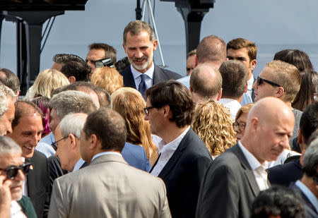 Spanish King Felipe stands after a ceremony in memory of victims of the twin Islamist attacks on the Catalan capital and the coastal town of Cambrils that killed 16 people marking the first anniversary of the attacks at Plaza Catalunya, central Barcelona, Spain, August 17, 2018. REUTERS/Albert Salame