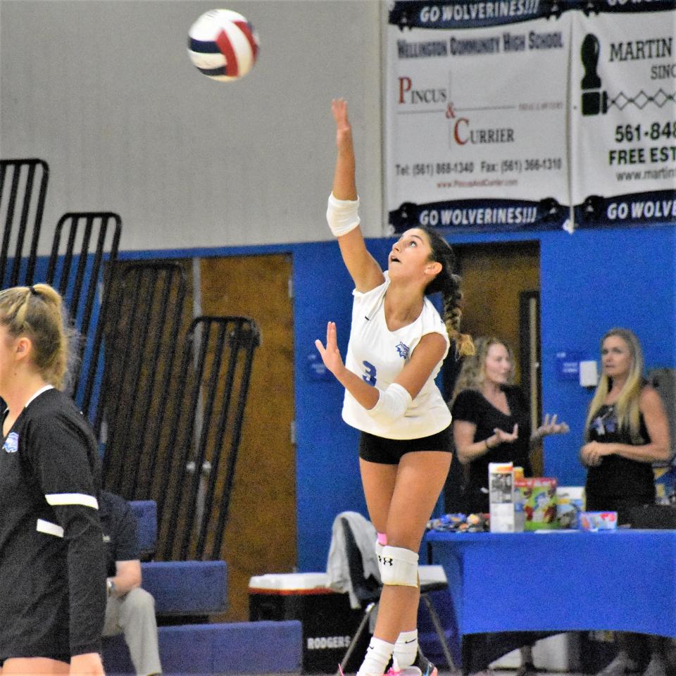 Wellington’s Jillian St. Leger rises to serve the ball during a regular season contest against Royal Palm Beach (Sept 7, 2023).