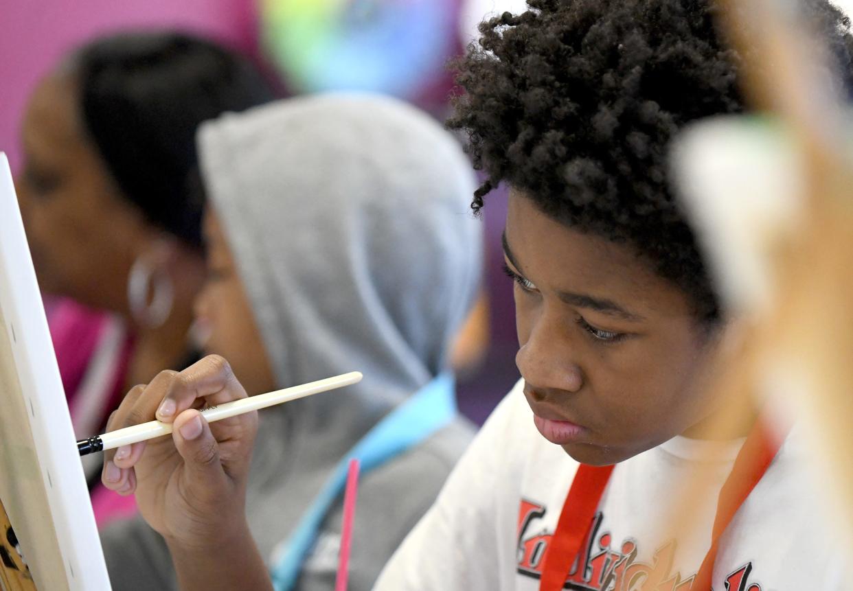 Daymir Arrington, 13, of Akron pays attention to details during a visit to Painting with a Twist in North Canton with his family.