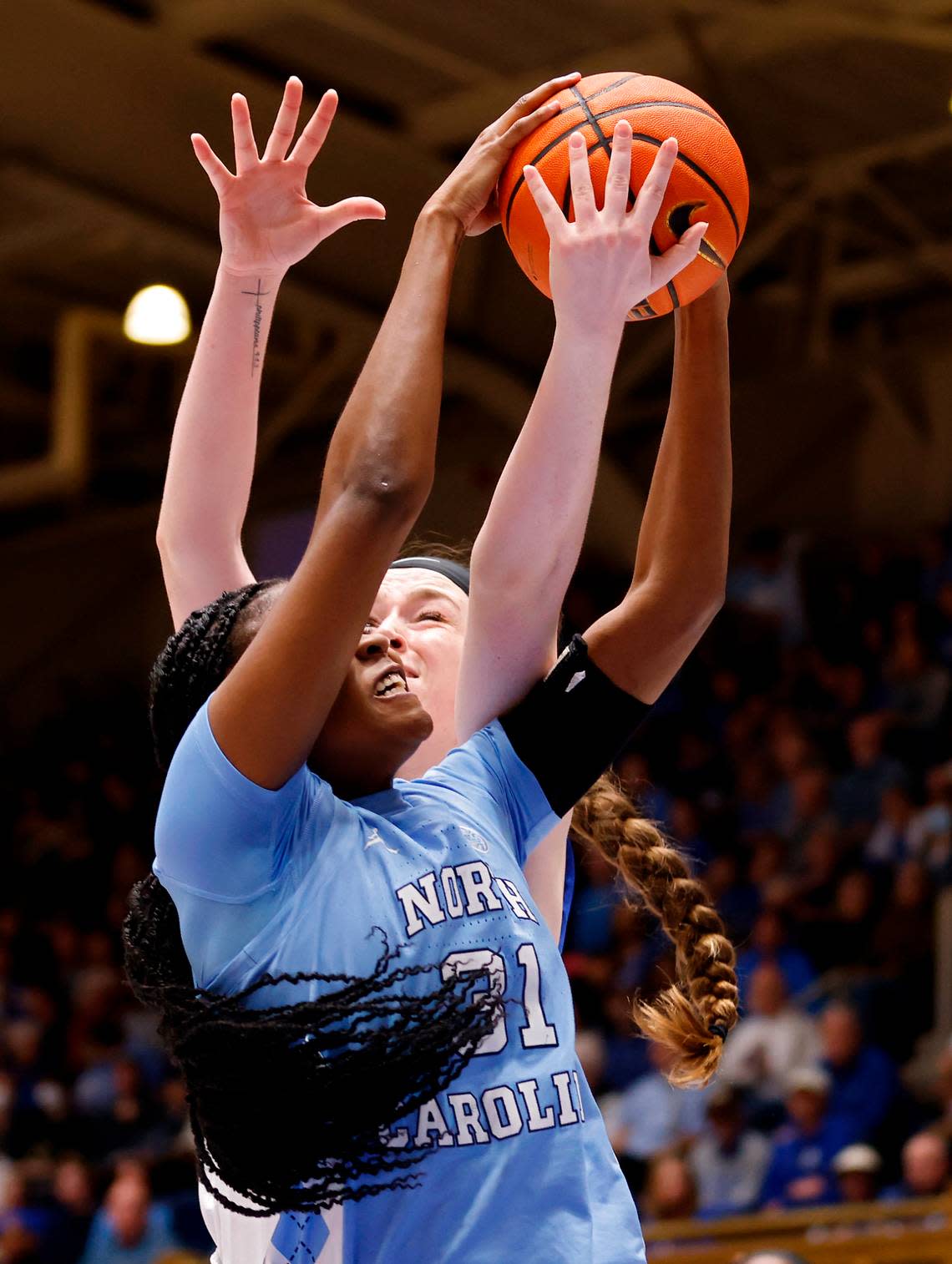 North Carolina’s Anya Poole pulls down a rebound away from Duke’s Kennedy Brown during the second half of the Tar Heels’ 45-41 win over Duke on Sunday, Feb. 26, 2023, at Cameron Indoor Stadium in Durham, N.C.