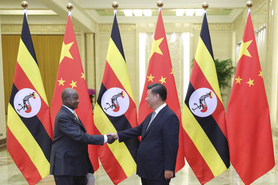 FILE - In this Thursday, Sept. 6, 2018 file photo, China's President Xi Jinping, right, shakes hands with Uganda's President Yoweri Museveni at the Great Hall of the People in Beijing, China. African leaders in 2020 are asking what China can do for them as the coronavirus pandemic threatens to destroy economies across a continent where Beijing is both the top trading partner and top lender. (Lintao Zhang/Pool File Photo via AP)