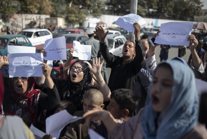 FILE-Afghan women chant during a protest in Kabul, Afghanistan, Thursday, Oct. 21, 2021. A U.K.-based rights group on Thursday, May 18, 2023 launched an interactive map documenting human rights abuses and violence against civilians since the Taliban seized power in Afghanistan nearly two years ago. (AP Photo/Ahmad Halabisaz, File)