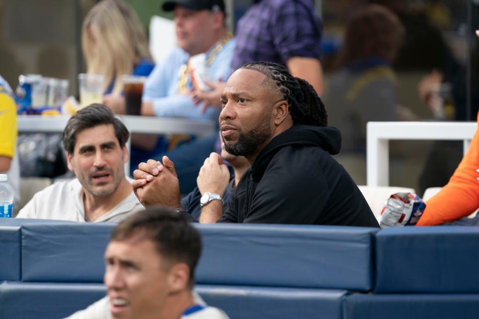 Arizona Cardinals former player Larry Fitzgerald Jr. (right) sits in a field box during the second quarter against the Los Angeles Rams at SoFi Stadium in Inglewood on Oct. 15, 2023.