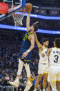 Utah Jazz guard Keyonte George (3) watches a dunk by Golden State Warriors guard Klay Thompson (11) during the first half of an NBA basketball game, Sunday, April 7, 2024, in San Francisco. (AP Photo/Nic Coury)