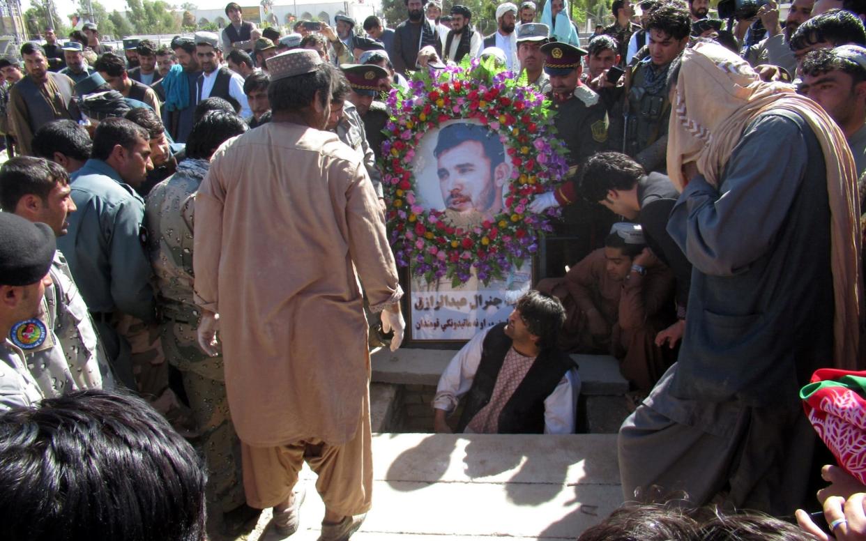 Mourners attend the burial of Gen Abdul Raziq, whose assassination has led to the delay of elections in Kandahar - REUTERS