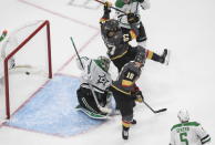Dallas Stars goalie Anton Khudobin (35) gives up an apparent goal as Vegas Golden Knights' Max Pacioretty (67) andReilly Smith (19) interfere with the goalie during the second period of Game 2 of the NHL hockey Western Conference final, Tuesday, Sept. 8, 2020, in Edmonton, Alberta. The goal was disallowed. (Jason Franson/The Canadian Press via AP)