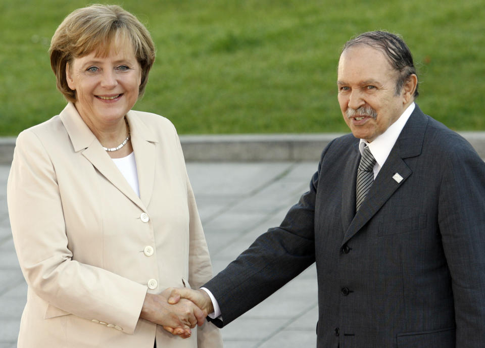 FILE - In this June 8, 2007 file photo, German Chancellor Angela Merkel welcomes President of Algeria Abdelaziz Bouteflika before a meeting with Africa outreach members in during the G8 summit in Heiligendamm. Former Algerian President Bouteflika, who fought for independence from France in the 1950s and 1960s and was ousted amid pro-democracy protests in 2019 after 20 years in power, has died at age 84, state television announced Friday, Sept. 17, 2021. (AP Photo/Misha Japaridze, File)