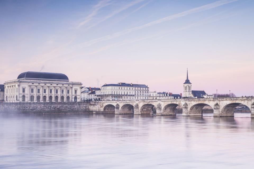 dawn over the river loire in the city of saumur, france