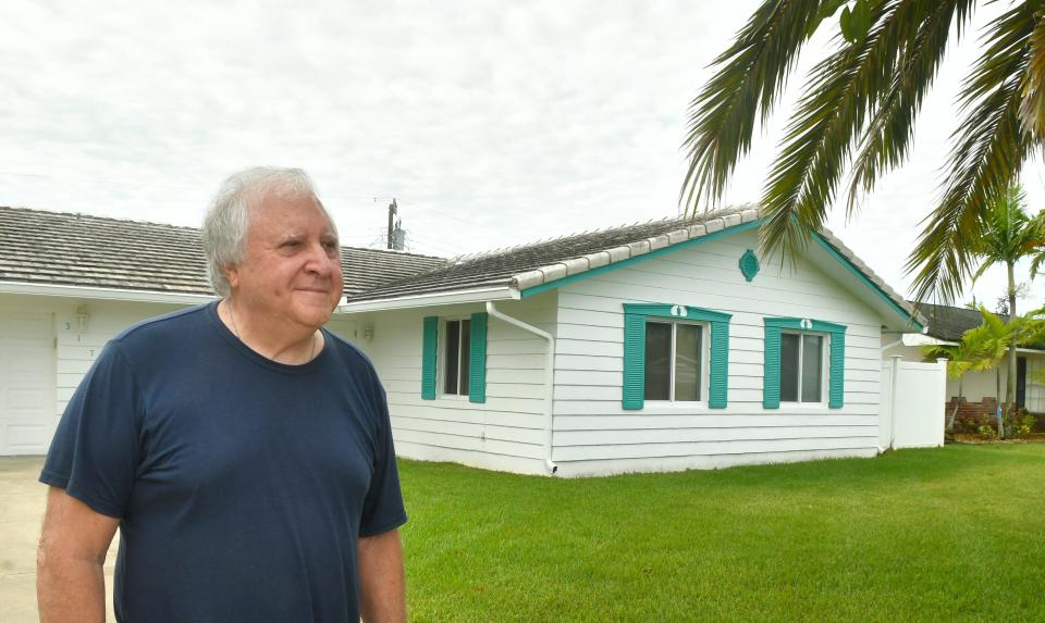 Frank Klotz stands in front of his home in the Venetian Way neighborhood of Cocoa Beach. Klotz said he doesn't like the fact that there are two vacation rentals on his block.