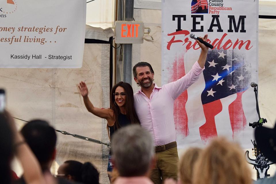 Rep. Lauren Boebert and Donald Trump Jr. wave to the crowd at the Freedom Fest hosted by the Pueblo County Republican Party at the state fairgrounds on July 8.