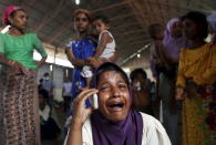 A Rohingya migrant who arrived in Indonesia by boat cries while speaking on a mobile phone with a relative in Malaysia, at a temporary shelter in Kuala Langsa in Indonesia's Aceh Province May 16, 2015. REUTERS/Roni Bintang