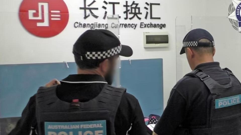 Police arrive at a branch of the Changjiang Currency Exchange on Wednesday. Picture: AFP