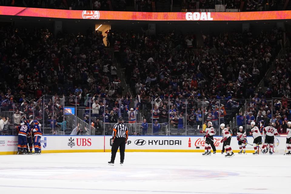 The New York Islanders celebrate after a goal by Bo Horvat during the third period of an NHL hockey game against the New Jersey Devils, Friday, Oct. 20, 2023, in Elmont, N.Y. (AP Photo/Frank Franklin II)