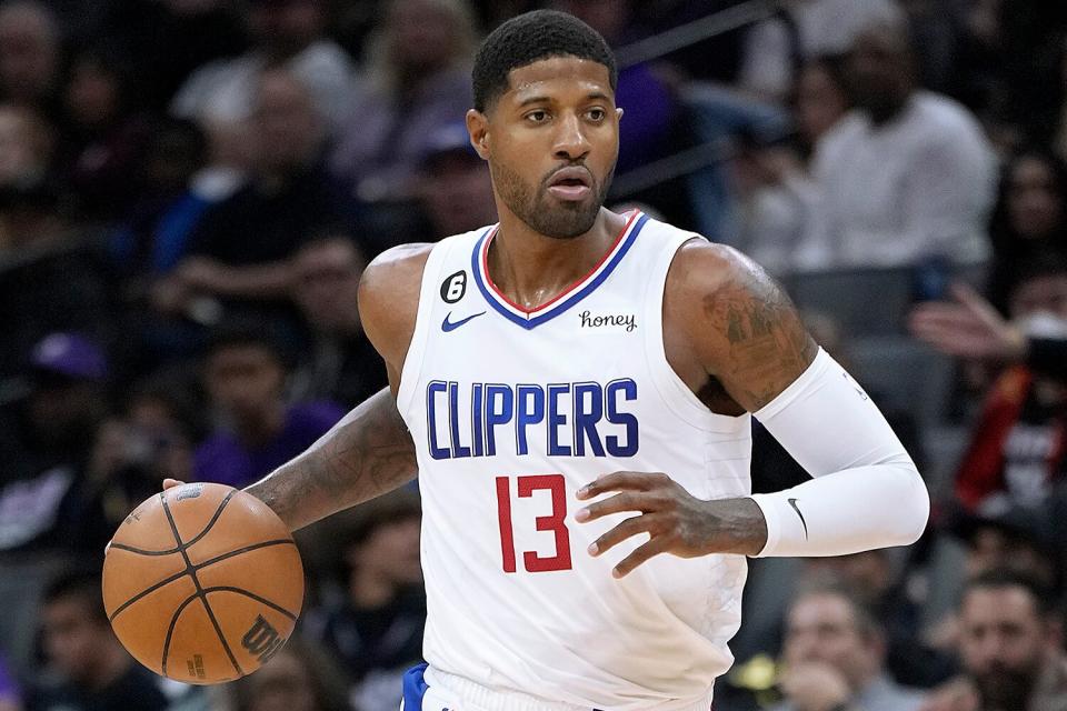 Paul George #13 of the LA Clippers dribbles the ball up court against the Sacramento Kings in the second quarter of an NBA basketball game at Golden 1 Center on October 22, 2022 in Sacramento, California.