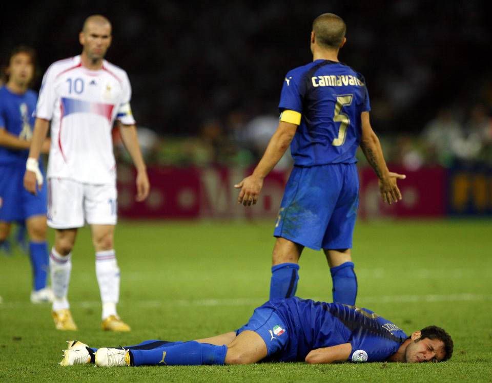 FILE - France's Zinedine Zidane, left, looks on after head butting Italy's Marco Materazzi in the chest as Italy's Fabio Cannavaro reacts during extra time in the final of the soccer World Cup soccer match at the Olympic Stadium in Berlin. Violence is part of the game in many sports. But when the Cleveland’s Myles Garrett ripped the helmet off Mason Rudolph and hit the Pittsburgh Steelers’ quarterback in the head with it, the Browns’ defender crossed a line _ one that attracts the attention of authorities sometimes from within their sport and in other cases from criminal prosecutors. (AP Photo/Jasper Juinen, File)