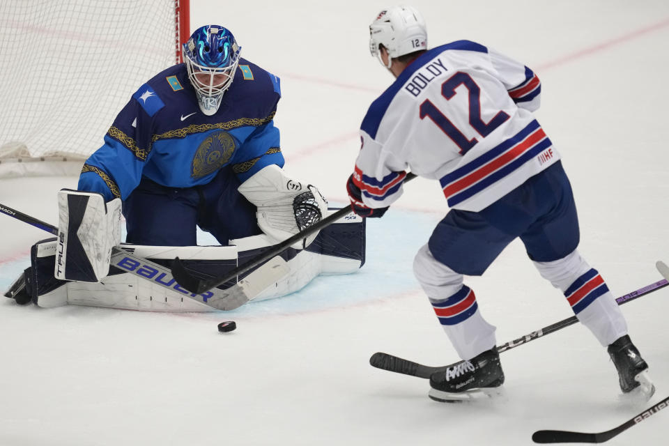 Kazakhstan's goalkeeper Nikita Boyarkin, left, makes a save in front of Unted States' Matt Boldy during the preliminary round match between United States and Kazakhstan at the Ice Hockey World Championships in Ostrava, Czech Republic, Sunday, May 19, 2024. (AP Photo/Darko Vojinovic)