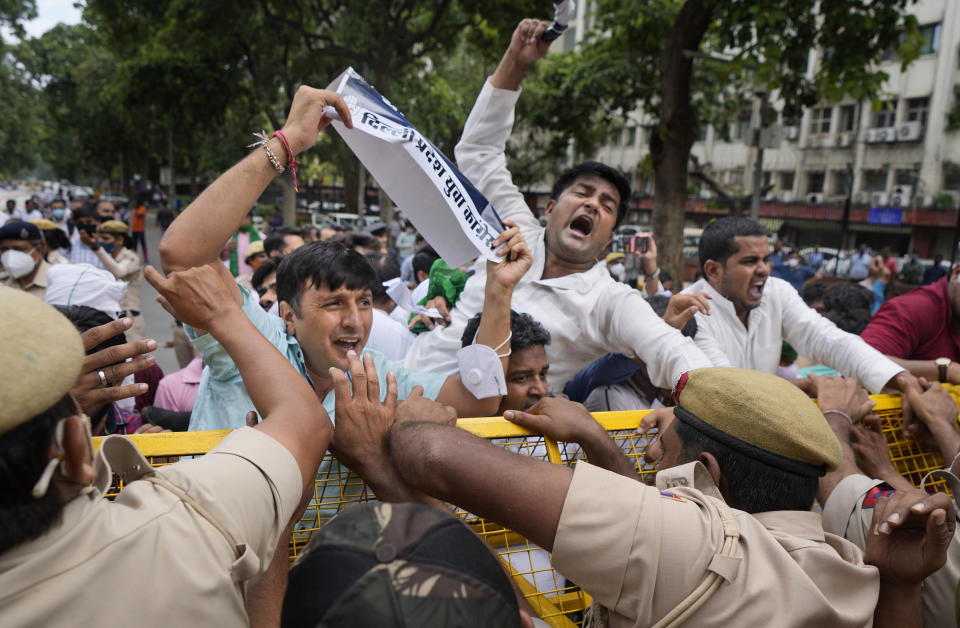 Indian Youth Congress members try to breach a police barricade during a protest held to mark Indian Prime Minister Narendra Modi's birthday in New Delhi, India, Friday, Sept.17, 2021. Youth members of main opposition Congress party clashed with police during a street protest Friday demanding jobs as the country’s economy recovered from the impact of the COVID-19 pandemic that triggered massive unemployment in the country. The march took place as supporters of Prime Minister Narendra Modi celebrated his birthday as he turned 71 on Friday. (AP Photo/Manish Swarup)