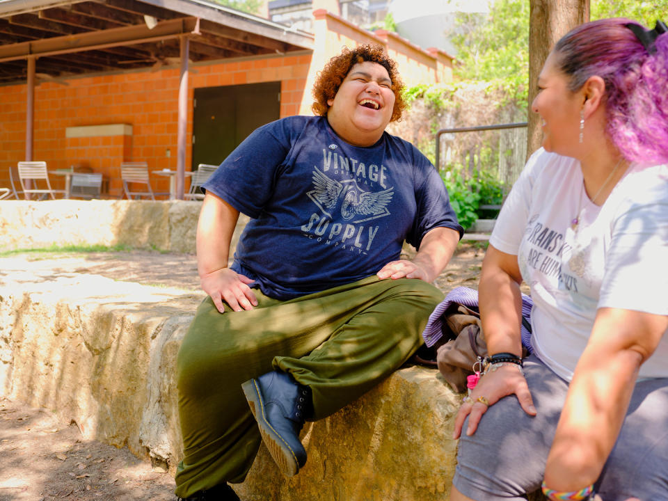 Vienna, 16, sits with their mom in San Antonio. Vienna will start college in the fall and hopes to study journalism. They say they are fascinated by the way “journalism affects how we as a society get our information.” In their future reporting, Vienna hopes to elevate trans and nonbinary voices.<span class="copyright">Annie Flanagan for TIME</span>