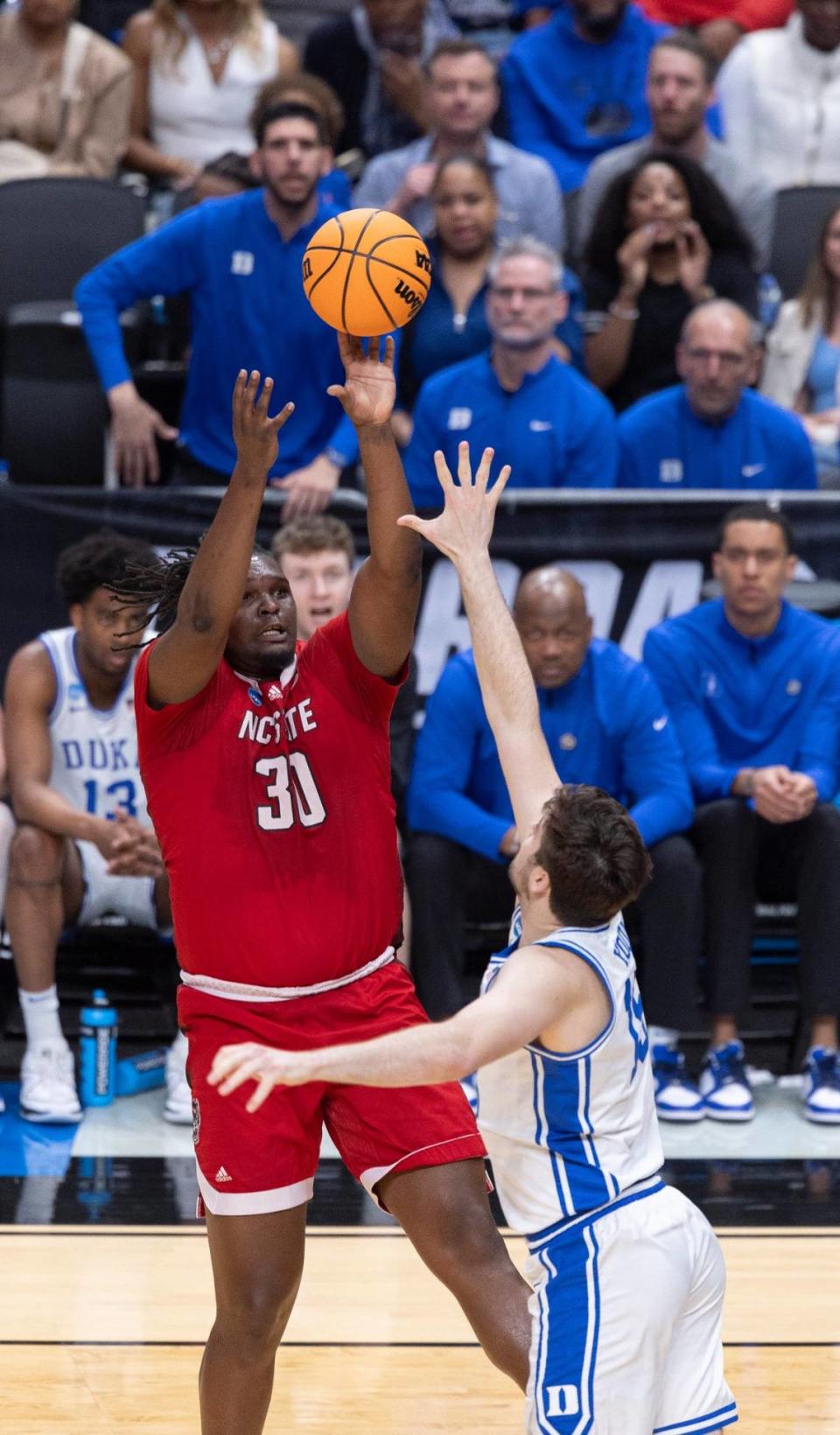 N.C. State’s D.J. Burns Jr. (30) puts up a shot over Duke’s Ryan Young (15) in the first half during the NCAA South Regional final on Sunday, March 31, 2024 at the American Airlines Center in Dallas, Texas.