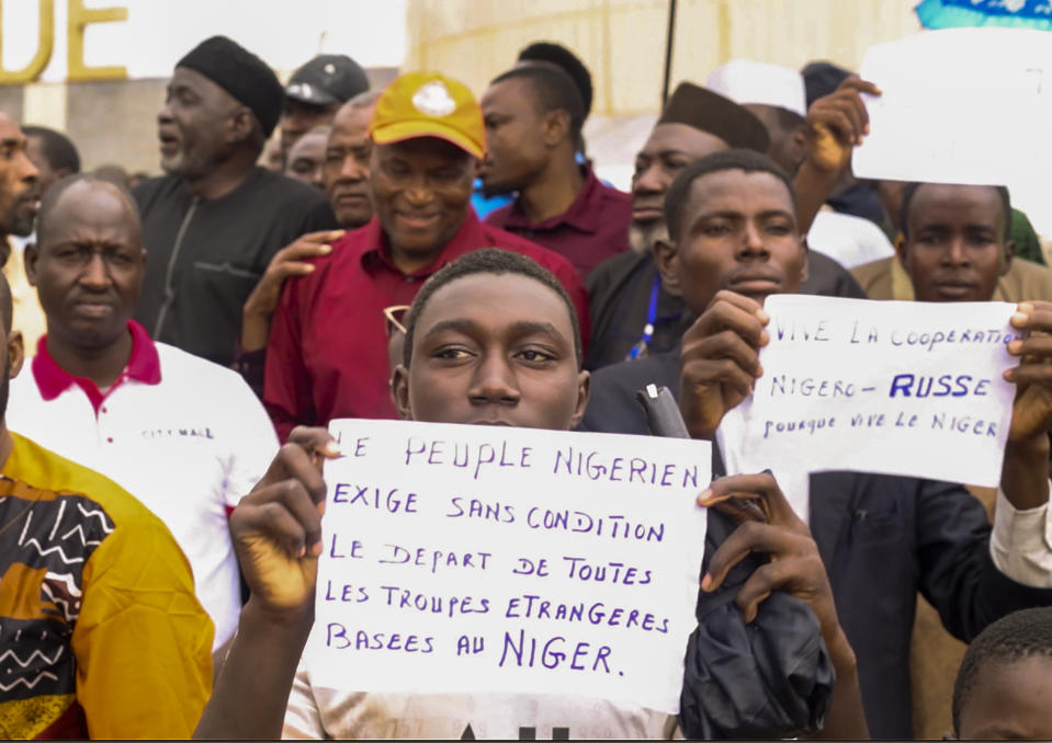 Supporters of mutinous soldiers demonstrate in Niamey, Niger, Thursday July 27 2023. Governing bodies in Africa condemned what they characterized as a coup attempt Wednesday against Niger's President Mohamed Bazoum, after members of the presidential guard declared they had seized power in a coup over the West African country's deteriorating security situation. The signs read: "The Nigeriens people demand without conditions the departure of all foreign troops based in Niger" and "Long Live the Russia-Niger cooperation" (AP Photo)