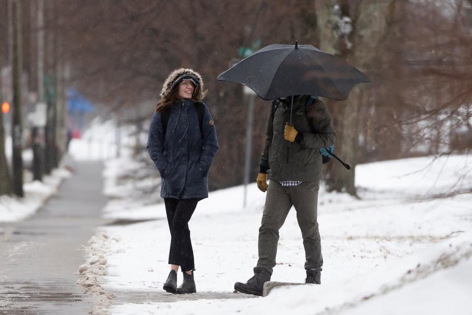 Pedestrians make their way through wind and sleet in Halifax on Wednesday, Jan. 10, 2024. (Darren Calabrese/The Canadian Press - image credit)