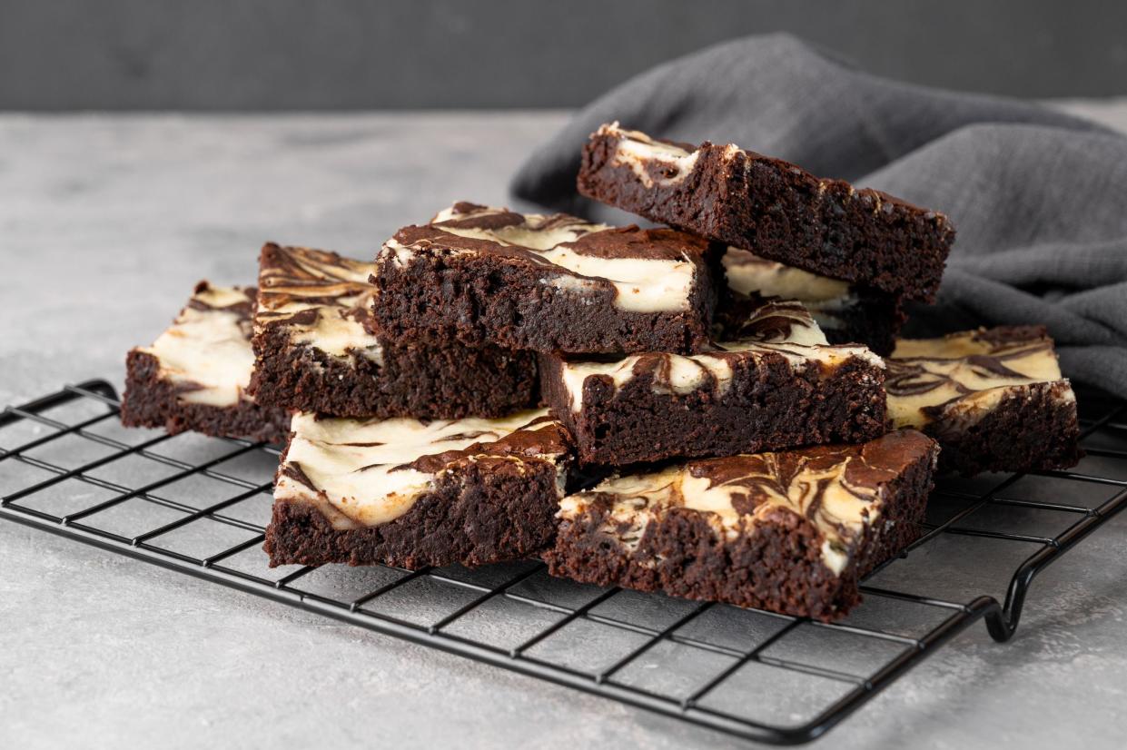 Delicious chocolate brownie cheesecake on a gray concrete background. Copy space, selective focus