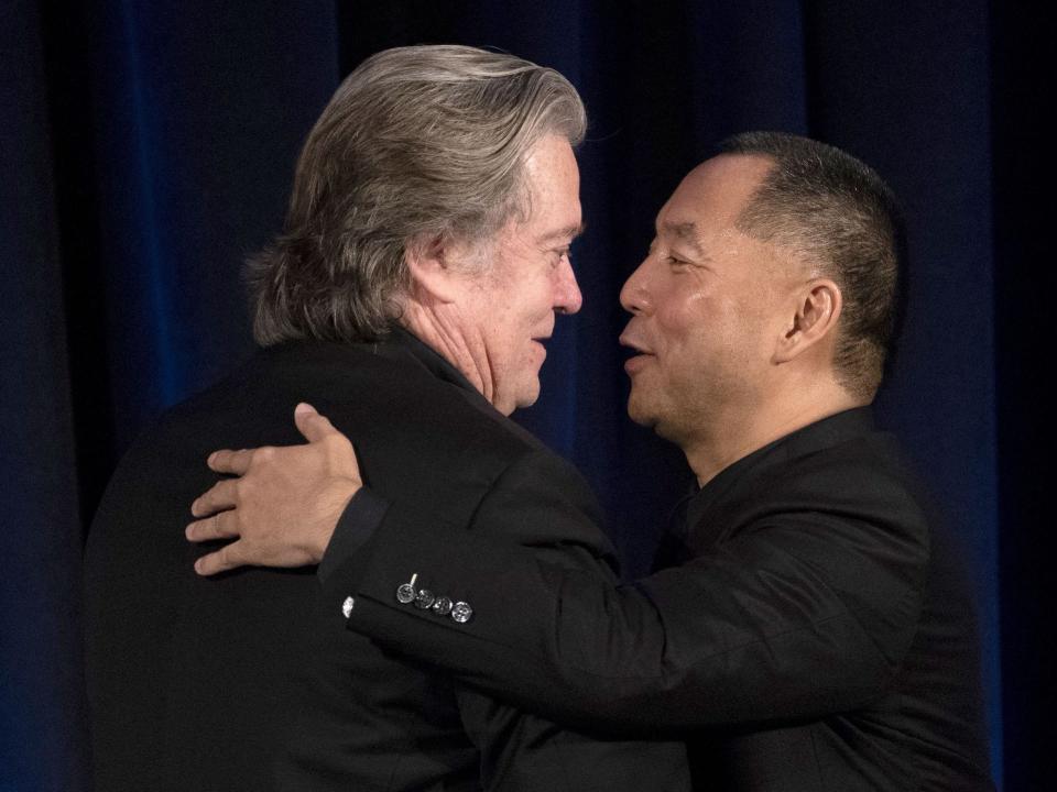 Former White House Chief Strategist Steve Bannon greets Chinese billionaire Guo Wengui before introducing him at a news conference on November 20, 2018.