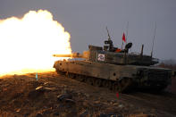 Japanese Ground-Self Defense Force (JGDDF) Type 90 tank fires at a target during an annual exercise at the Minami Eniwa Camp Tuesday, Dec. 7, 2021, in Eniwa, Japan's northern island of Hokkaido. Dozens of tanks are rolling over the next two weeks on Hokkaido, a main military stronghold for a country with perhaps the world's most little known yet powerful army. (AP Photo/Eugene Hoshiko)