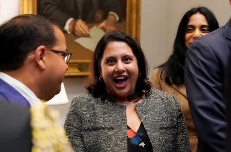 Neomi Rao (C), the administrator of the White House Office of Information and Regulatory Affairs, reacts after U.S. President Donald Trump announced that he is nominating her to replace Supreme Court Justice Brett Kavanaugh on the U.S. D.C. Circuit Court of Appeals during a Diwali ceremonial lighting of the Diya at the White House in Washington, U.S. November 13, 2018. REUTERS/Jonathan Ernst