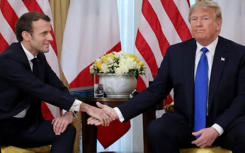 Trump and Macron shake hands - Credit: AFP