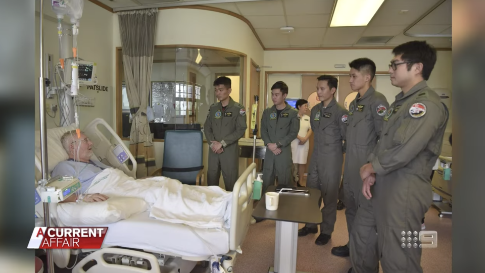 Mr McGinty in hospital with the Royal Singapore Air Force crew who saved him. Source: ACA