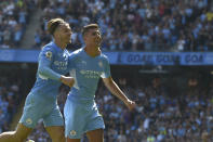 Manchester City's Rodrigo, right, celebrates after scoring his side's fourth goal during the English Premier League soccer match between Manchester City and Arsenal at Etihad stadium in Manchester, England, Saturday, Aug. 28, 2021. (AP Photo/Rui Vieira)