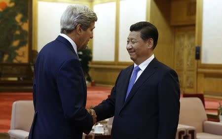 U.S. Secretary of State John Kerry (L) meets with China's President Xi Jinping at the Great Hall of the People in Beijing July 10, 2014. REUTERS/Jim Bourg