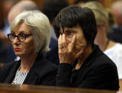 The aunt of Oscar Pistorius, Lois Pistorius, left, and an unidentified relative, right, listen to forensic evidence during the trial of Oscar Pistorius in court in Pretoria, South Africa, Thursday March 13, 2014. Pistorius is charged with the shooting death of his girlfriend Reeva Steenkamp, on Valentines Day in 2013. (AP Photo/Themba Hadebe, Pool)