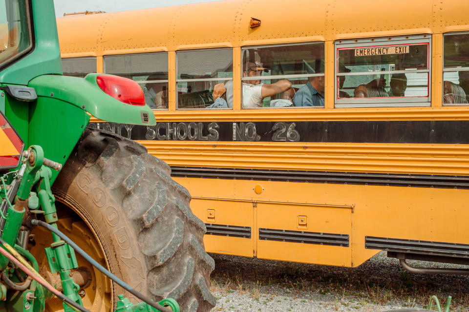 Employees of Jones and Church Farms tomato farm wait on the bus back to their housing after getting vaccinated on June 2<span class="copyright">Mike Belleme for TIME</span>