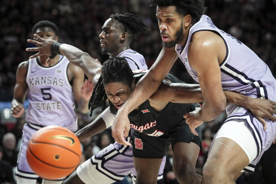 Houston forward Joseph Tugler, center, fights with Kansas State forward Will McNair Jr., for a rebound uring the first half of a NCAA college basketball game, Saturday, Jan. 27, 2024, in Houston. (Jon Shapley/Houston Chronicle via AP)