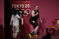 Laurel Hubbard of New Zealand walks on to the podium to compete in the women's +87kg weightlifting event at the 2020 Summer Olympics, Monday, Aug. 2, 2021, in Tokyo, Japan. (AP Photo/Luca Bruno)