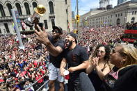 Toronto Raptors forward Kawhi Leonard, left to right, celebrates with Drake, Leonard's girlfriend Kishele Shipley and his mother Kim Robertson during the NBA basketball championship team's victory parade in Toronto, Monday, June 17, 2019. (Photo by Frank Gunn/The Canadian Press via AP)