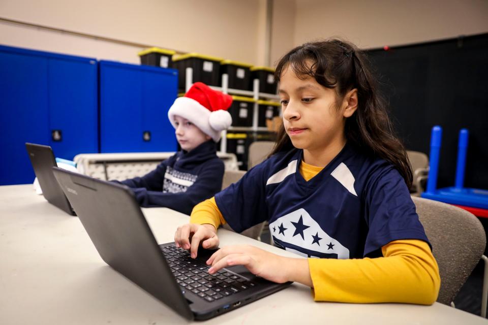 Daniela Garcia, 11, works on her computer with the Youth Coding League at Independence Public Library on Dec. 11.