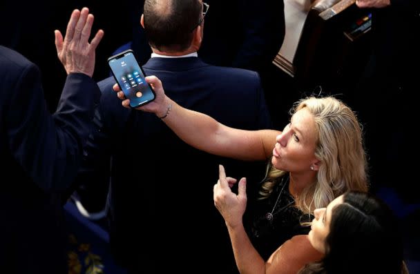 PHOTO: Rep.-elect Matt Rosendale (R-MT) refuses to talk with former President Donald Trump on a phone being offered by Rep.-elect Marjorie Taylor Greene (R-GA) at the U.S. Capitol Building, January 6, 2023, in Washington. (Chip Somodevilla/Getty Images)